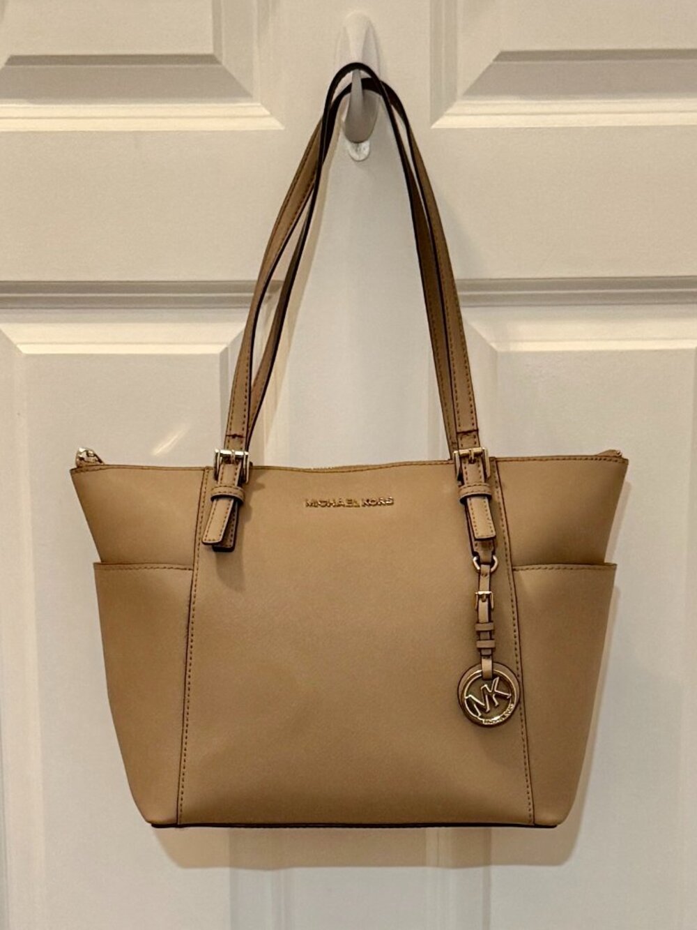 Michael Kors Beige Charlotte Zip Tote w/ gold-tone hardware and a branded Charm